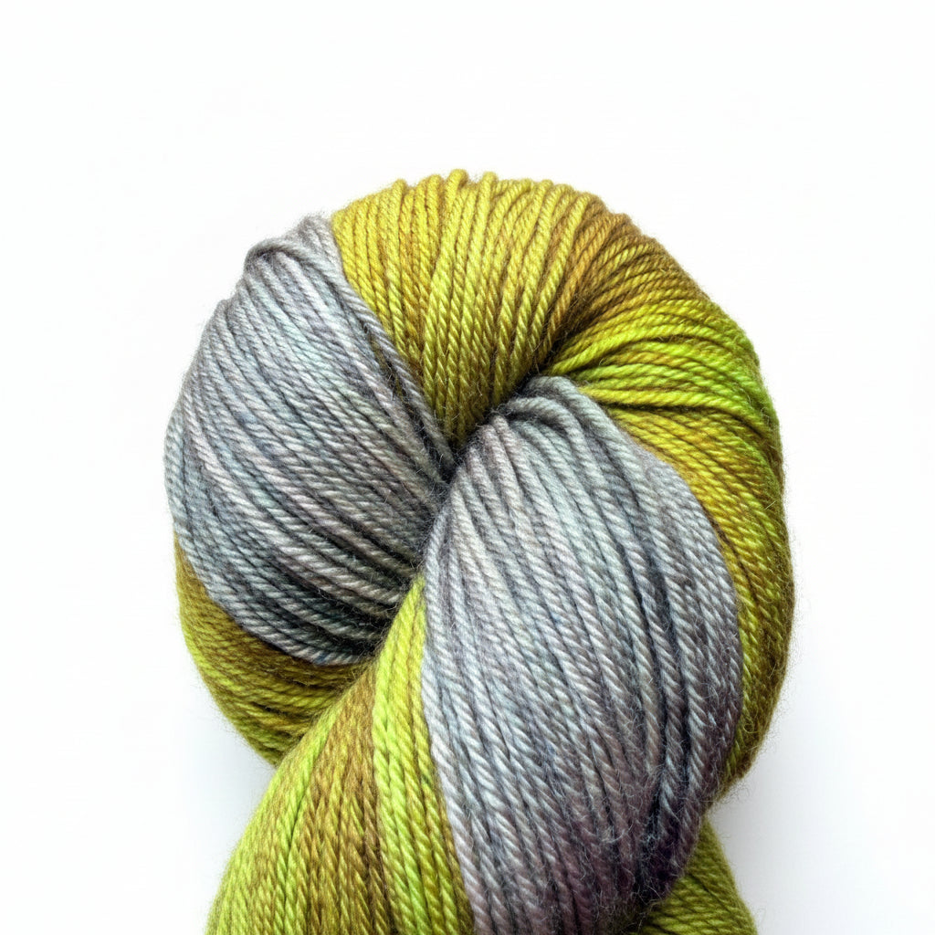 A skein of assigned pooling yarn with alternating sections of olive green, yellow, and gray